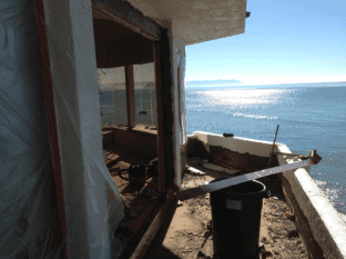 A deck in the midst of being repaired--it overlooks the ocean
